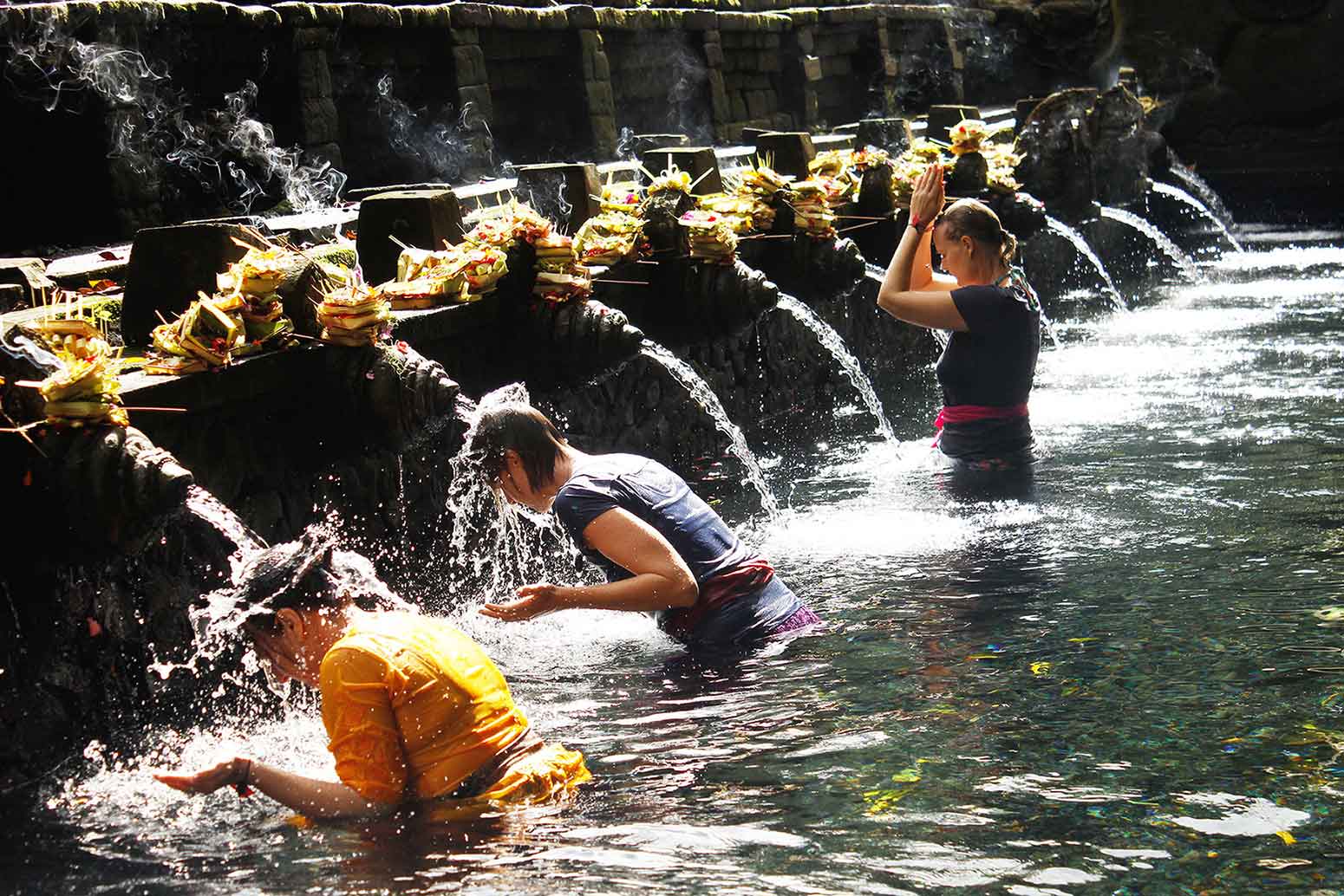 The water bassin in Tirta Empul with people